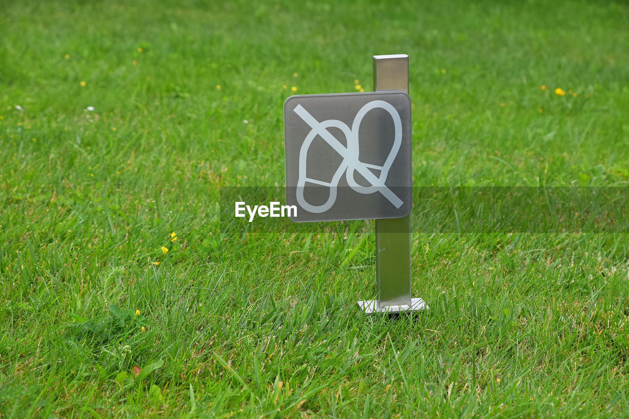 INFORMATION SIGN ON GRASS FIELD