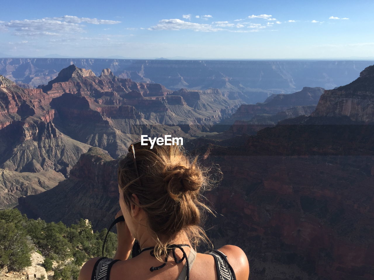 Rear view of woman and landscape against sky