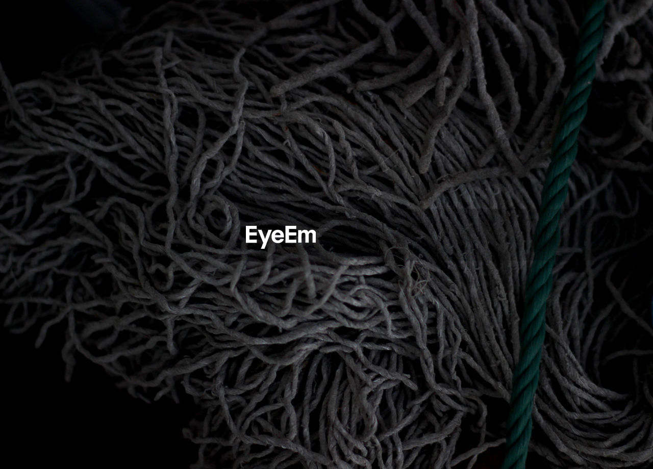 Directly above view of rope and strings on black background