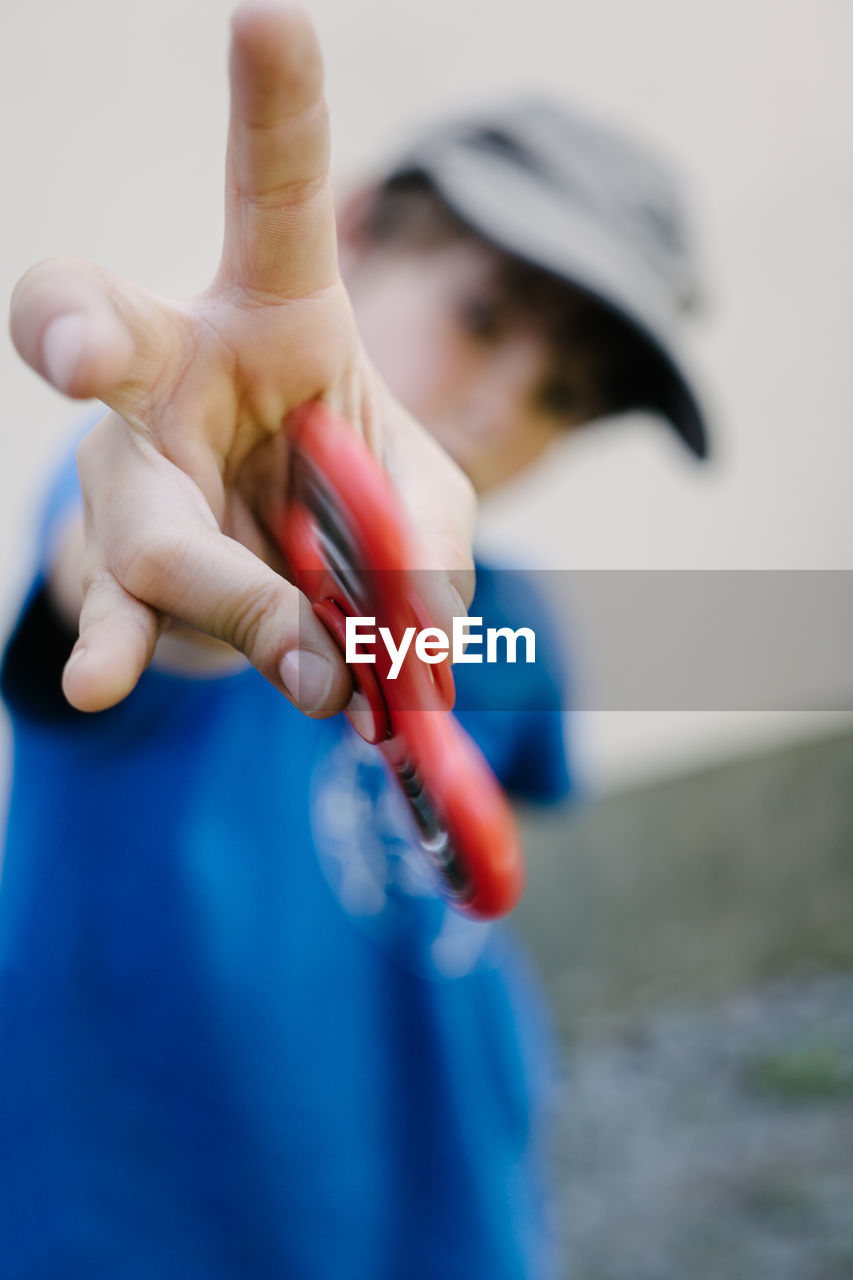 Close-up of boy with fidget spinner toy