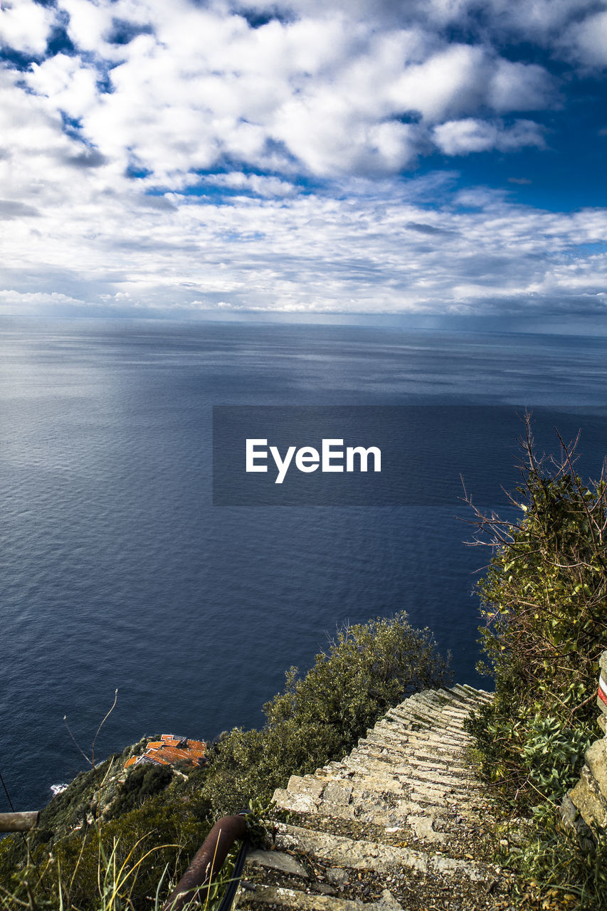 High angle view of sea and stairs against sky 