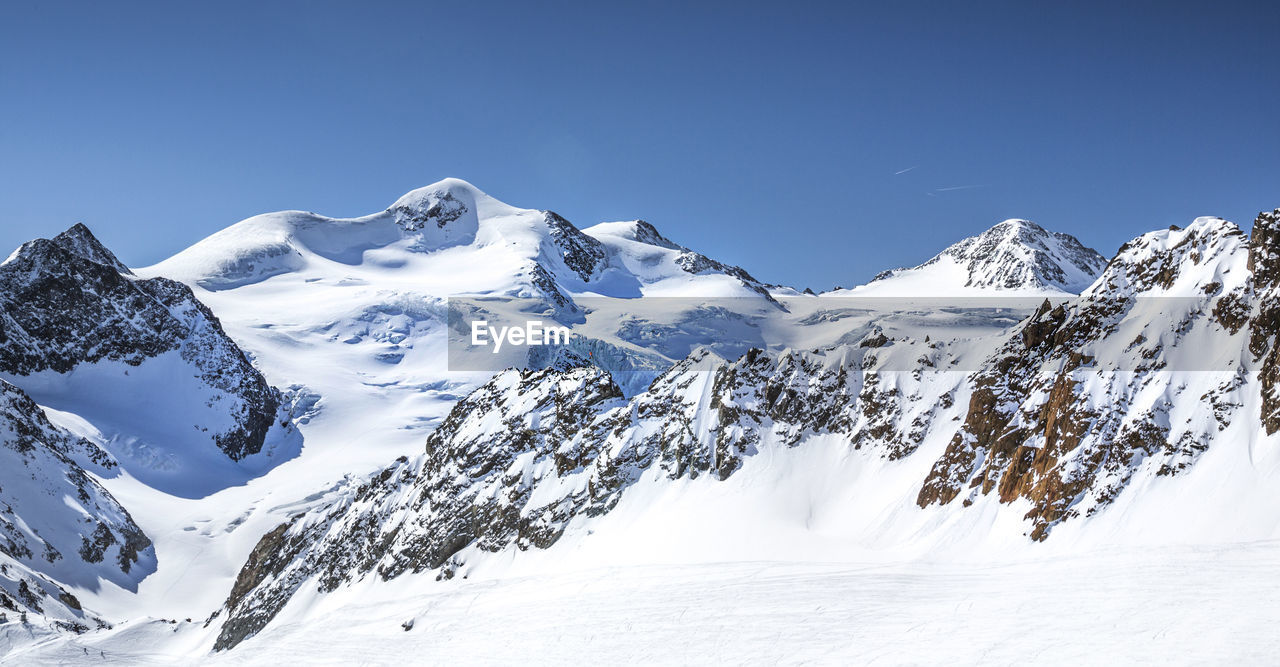 SCENIC VIEW OF SNOWCAPPED MOUNTAINS AGAINST CLEAR SKY