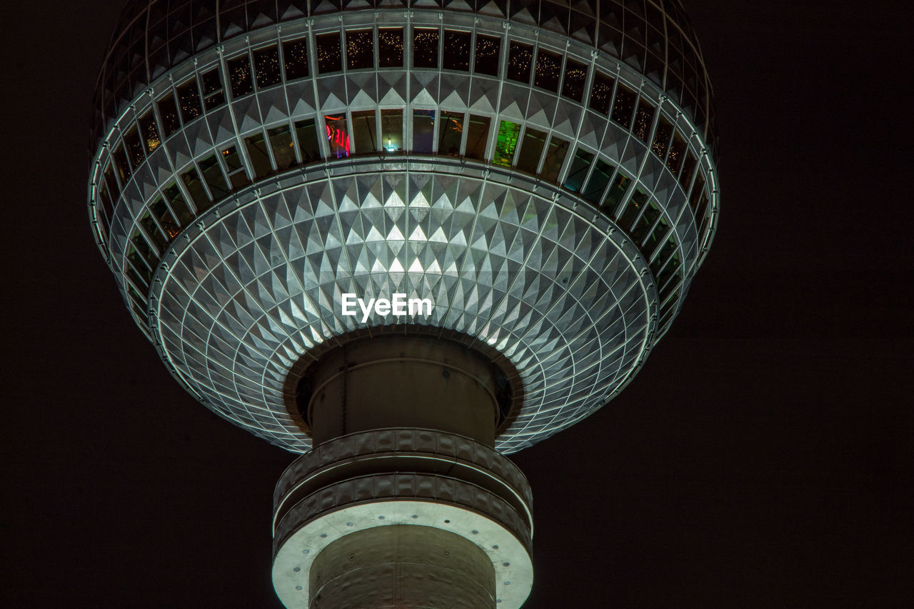 LOW ANGLE VIEW OF ILLUMINATED COMMUNICATIONS TOWER