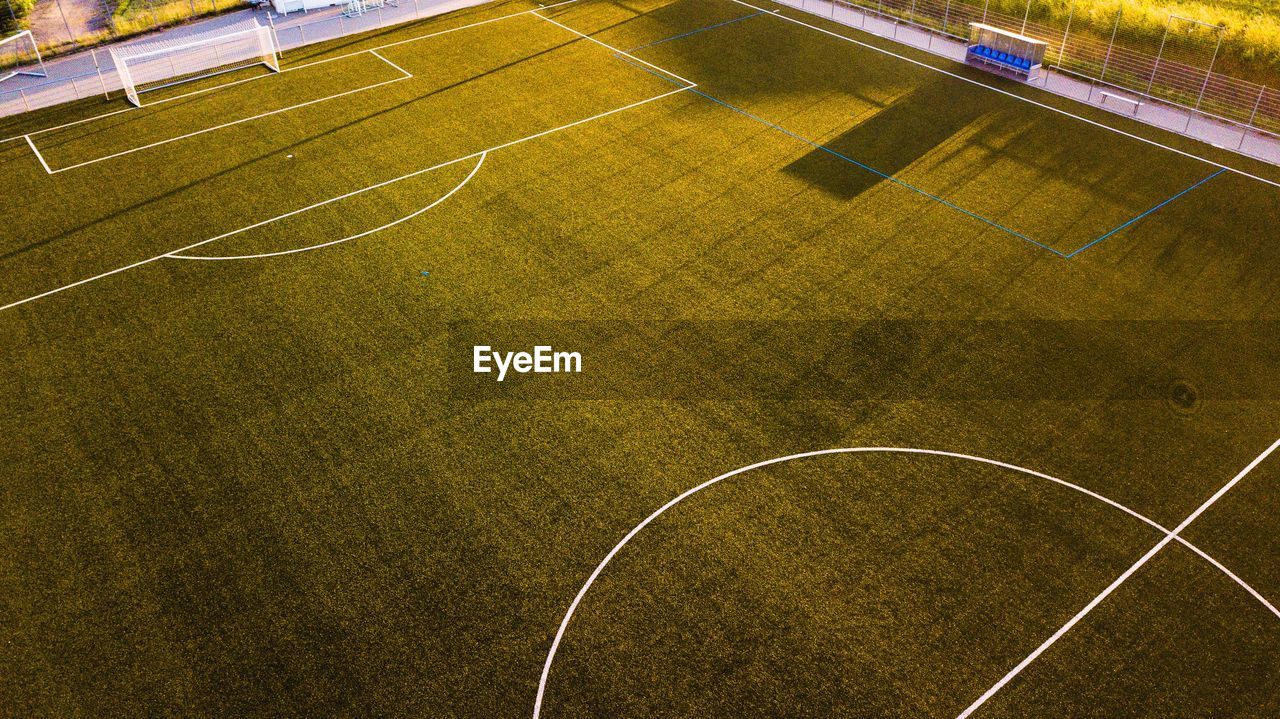 High angle view of empty soccer field during sunset