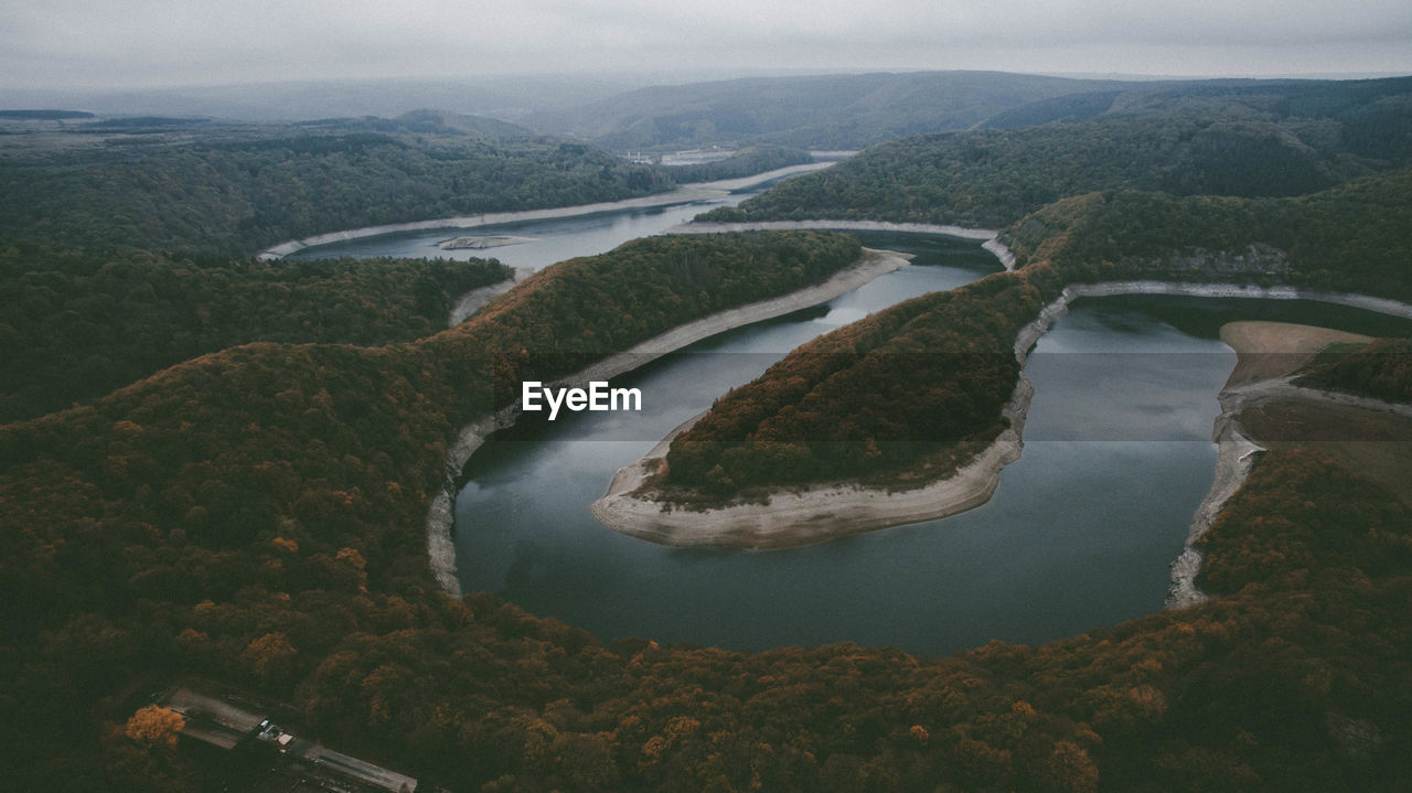 HIGH ANGLE VIEW OF RIVER AMIDST MOUNTAINS