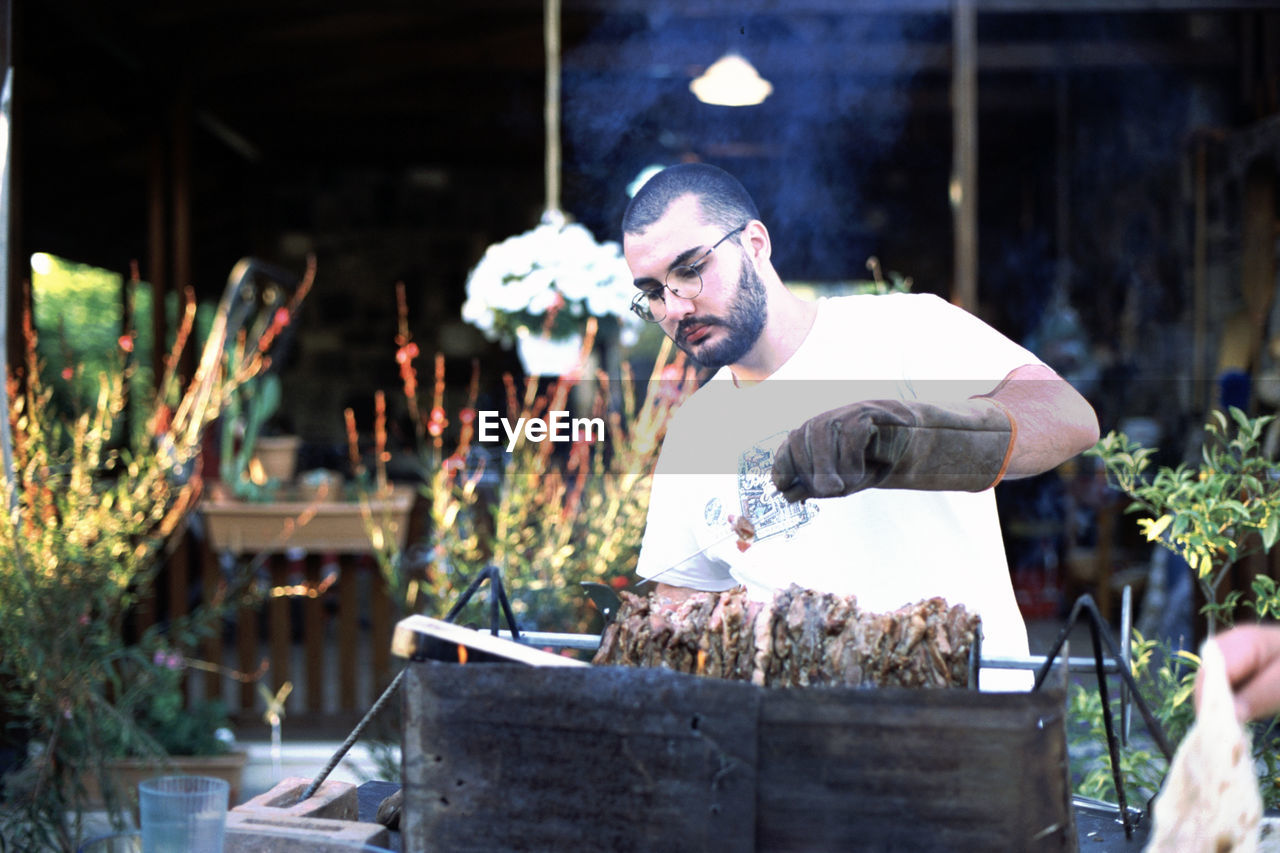 MIDSECTION OF MAN HOLDING FLOWER