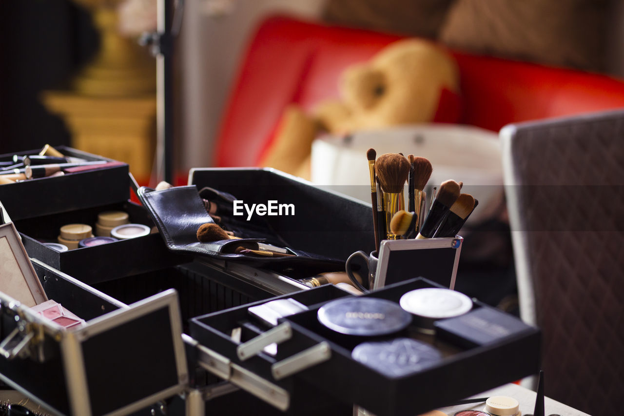 Dedicated focus make-up converter on makeup artist's table with lots of makeup artist tools.