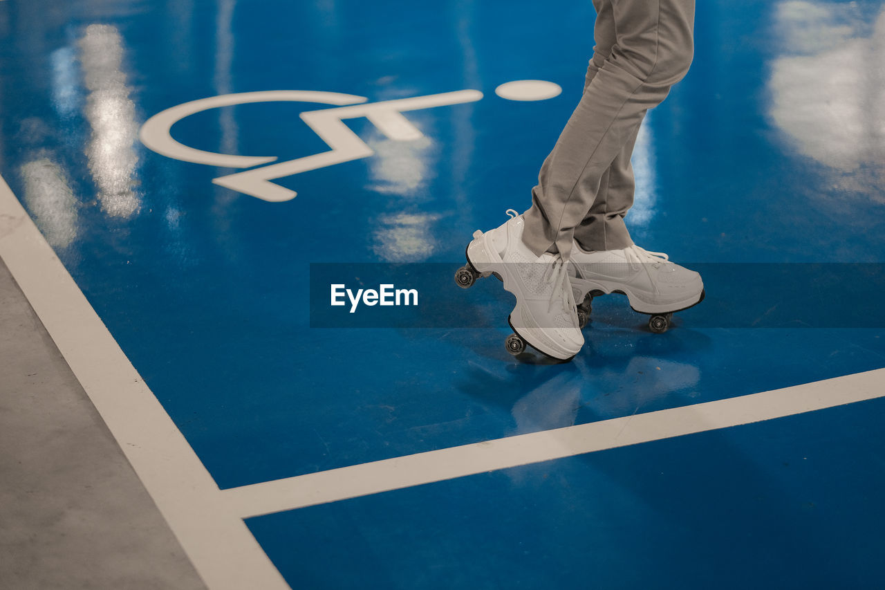 A girl skater at the disable parking