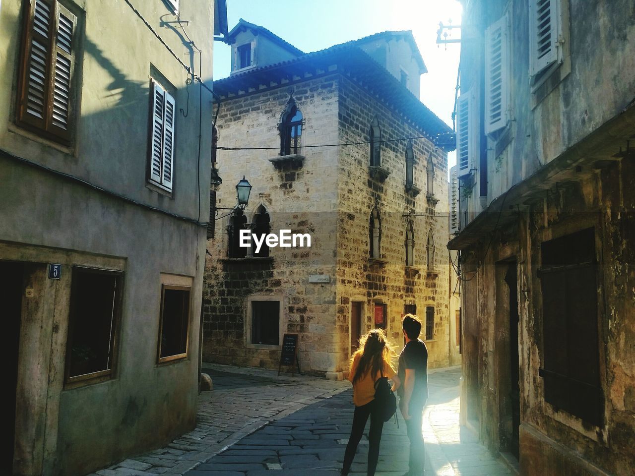 Couple standing amidst buildings in vodnjan