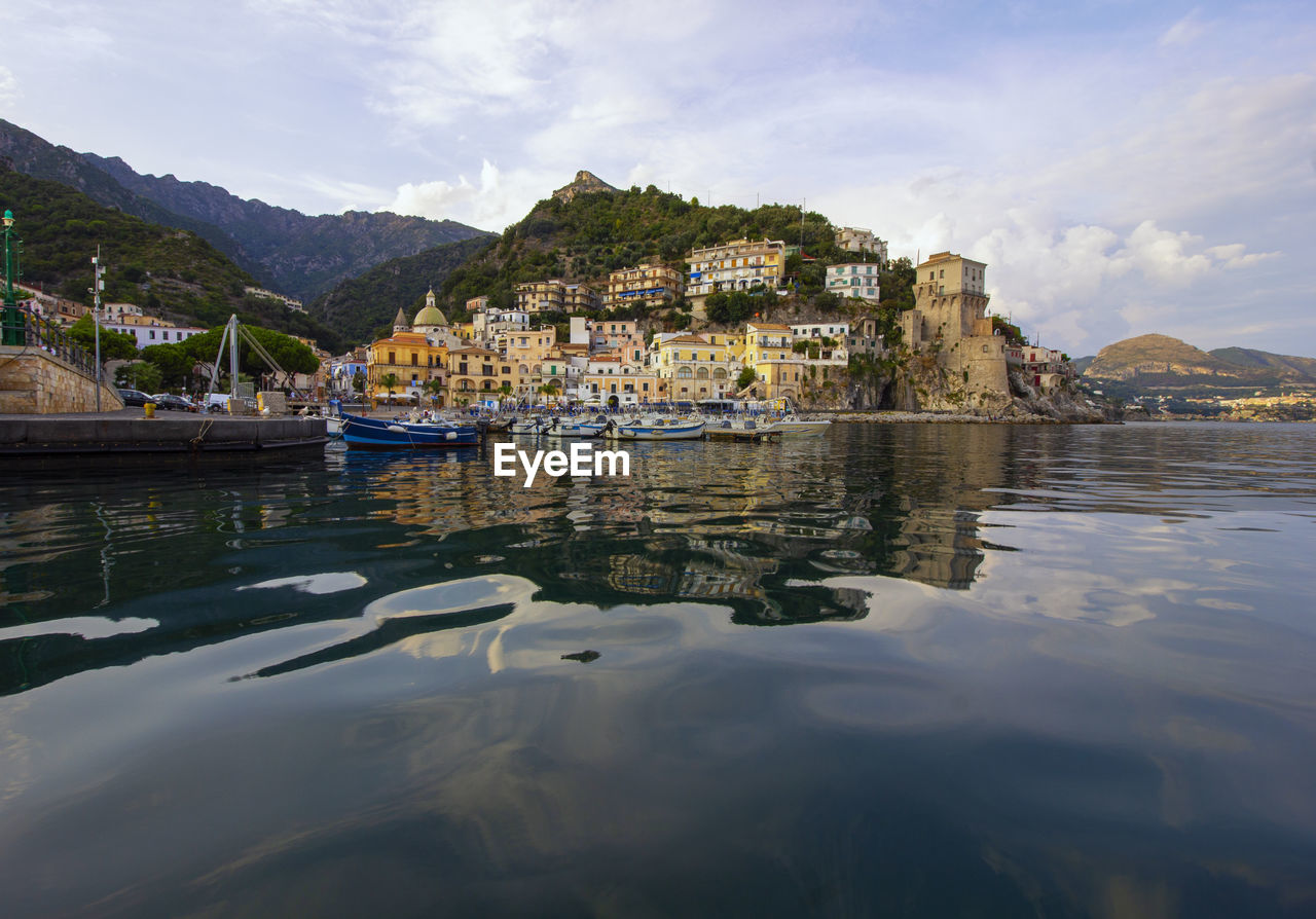 SAILBOATS IN SEA AGAINST BUILDINGS