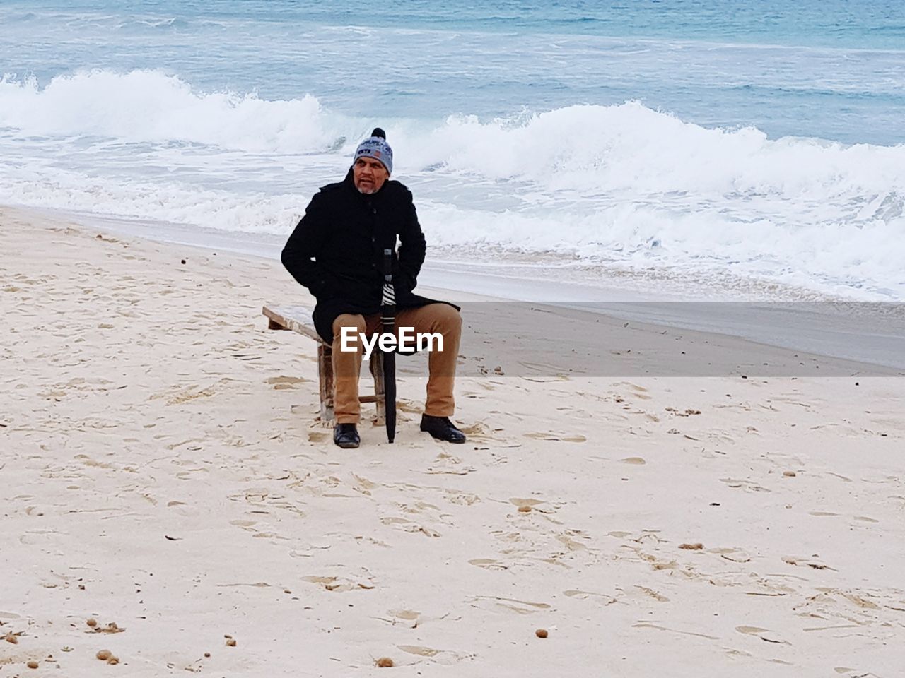 Full length of man sitting at beach