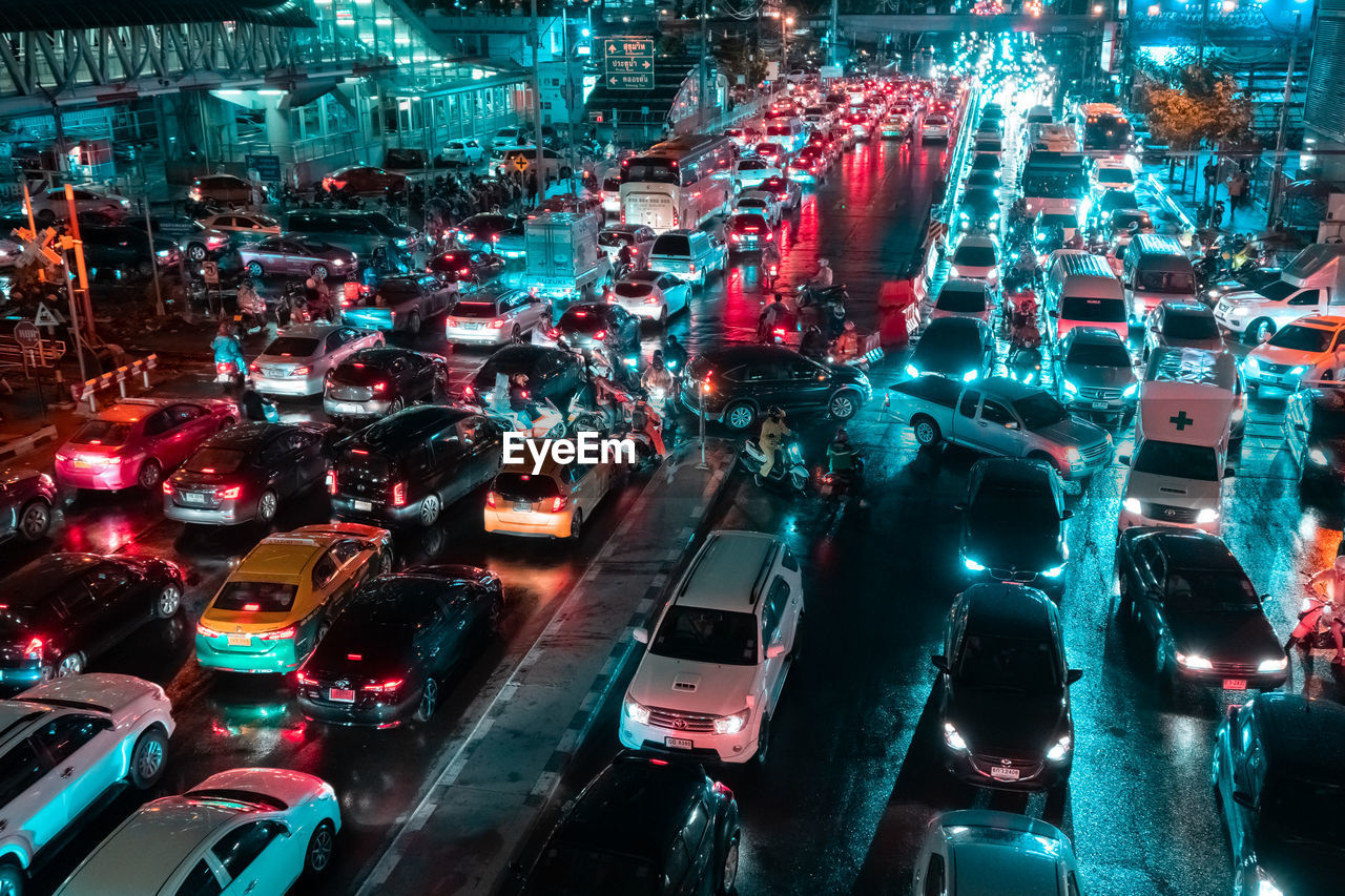 HIGH ANGLE VIEW OF VEHICLES ON CITY STREET AT NIGHT