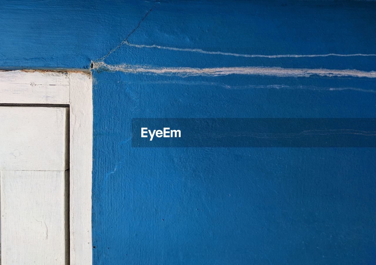 Close-up of blue wall against building