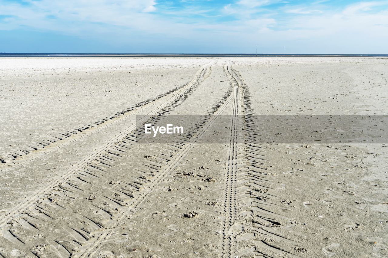 TIRE TRACKS ON BEACH