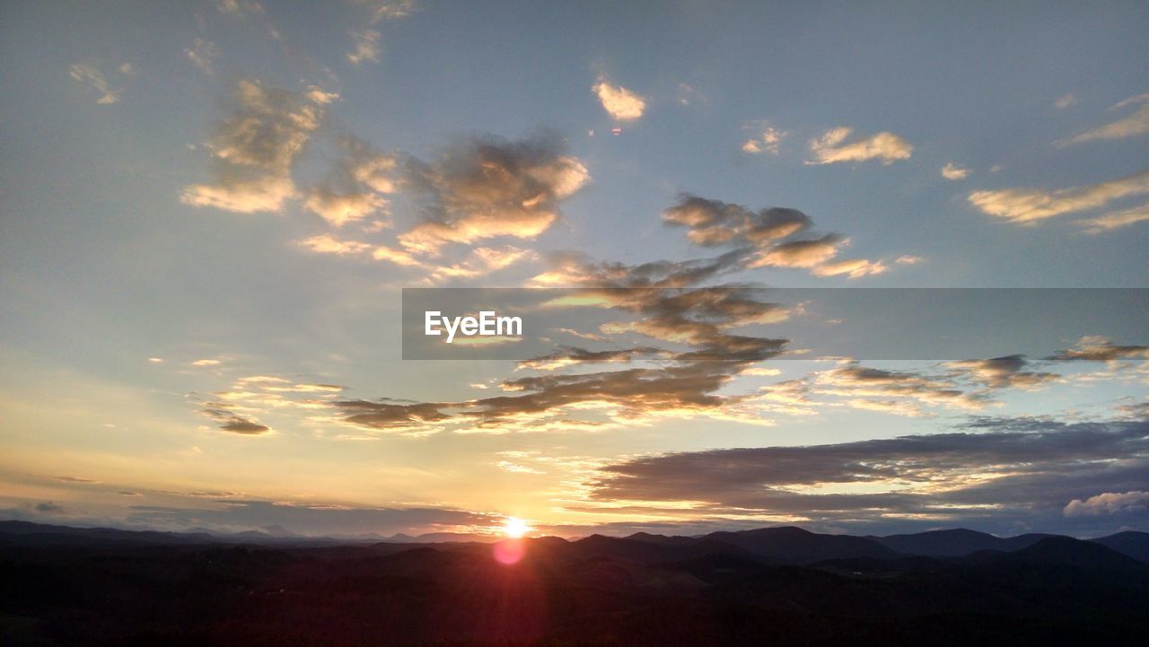 Scenic view of silhouette mountains against sky during sunset