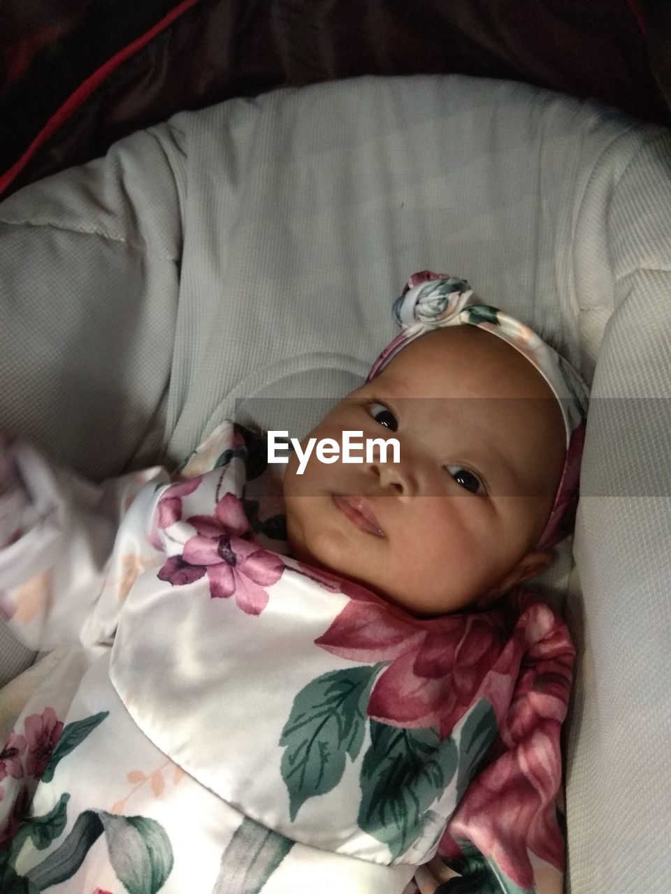 HIGH ANGLE PORTRAIT OF CUTE BABY LYING ON BED