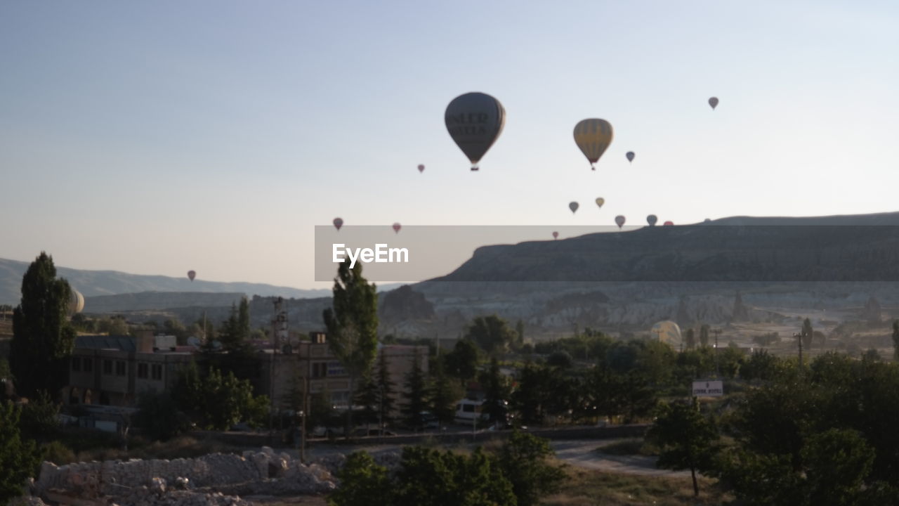 HOT AIR BALLOONS FLYING OVER MOUNTAIN