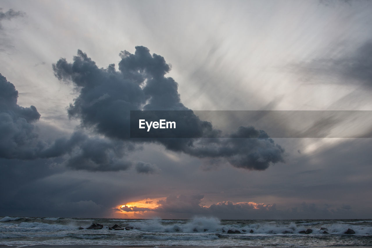 Scenic view of sea against storm clouds