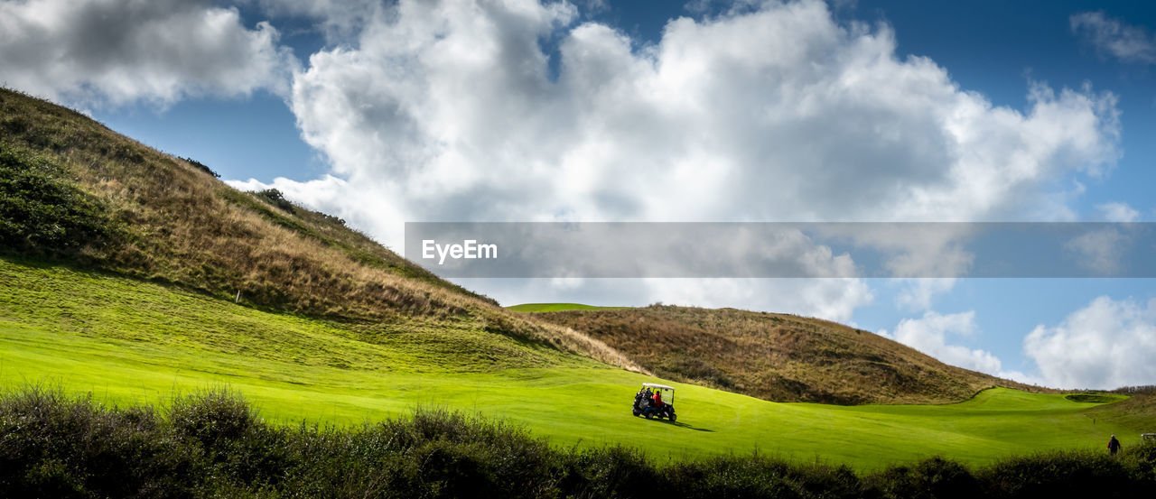 SCENIC VIEW OF GREEN LANDSCAPE AGAINST SKY