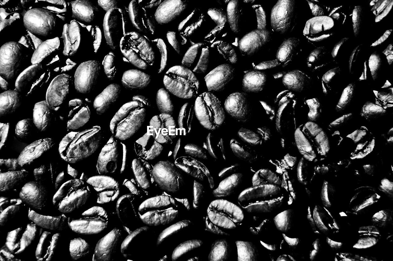 FULL FRAME SHOT OF ROASTED COFFEE BEANS IN BACKGROUND