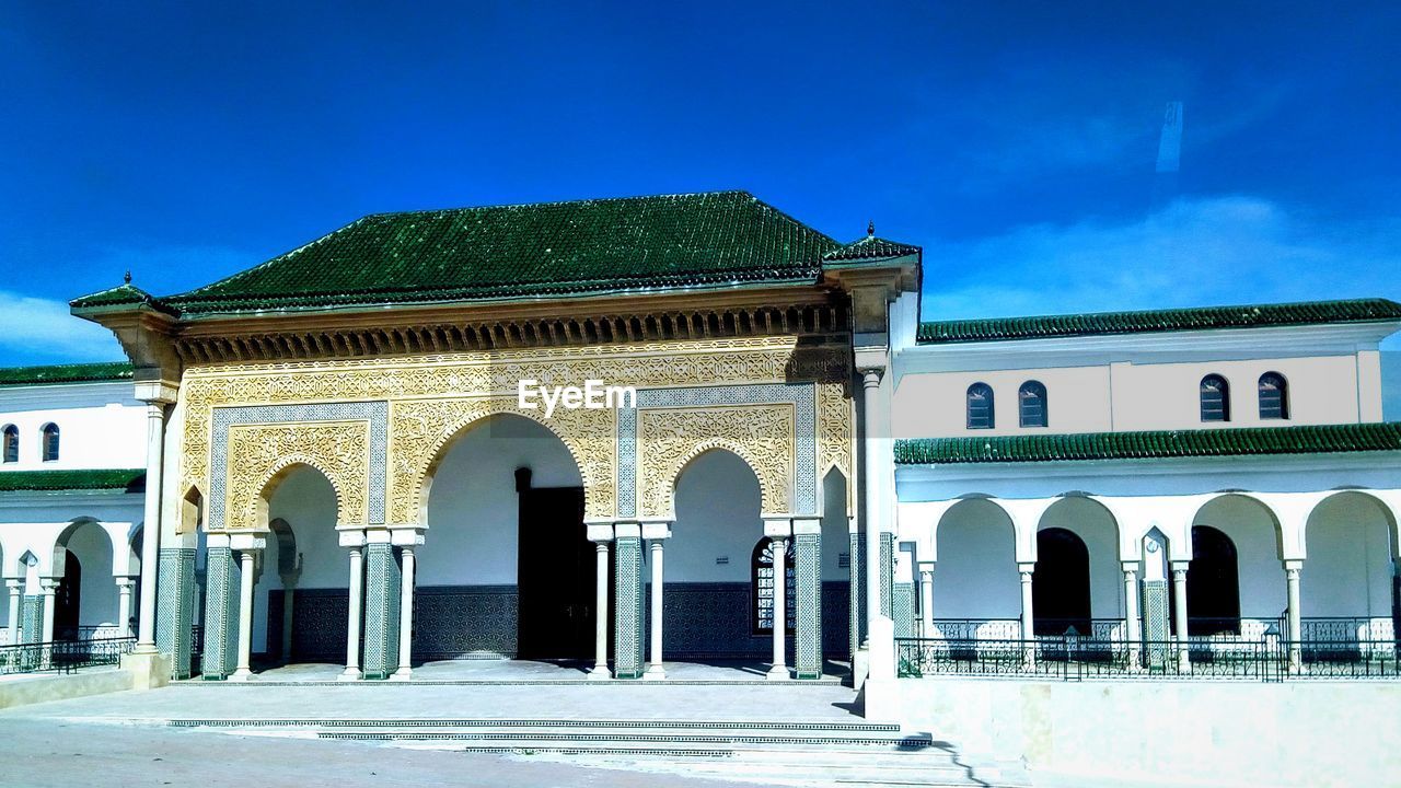 FACADE OF HISTORICAL BUILDING AGAINST BLUE SKY