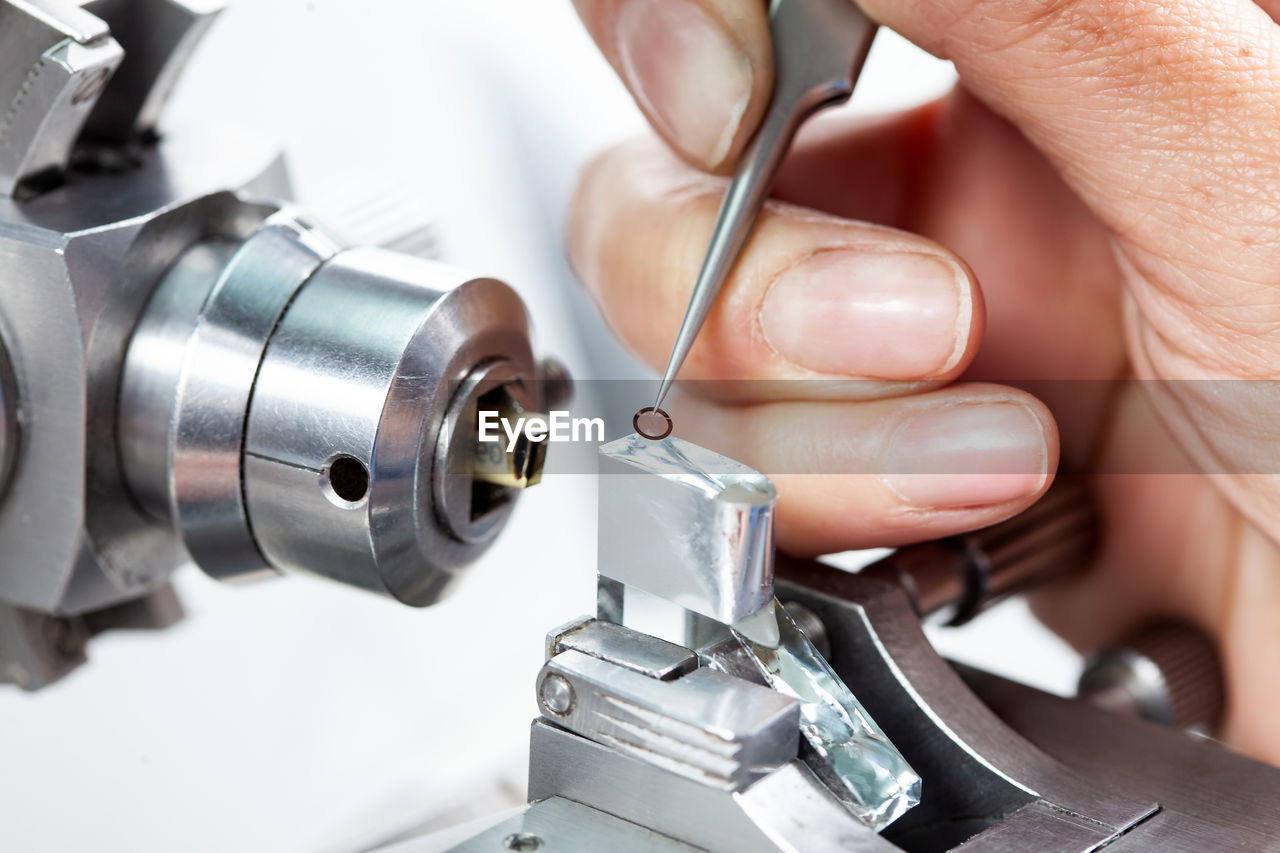 Closeup of a female scientist placing a sample on a transmission electron microscopy grid