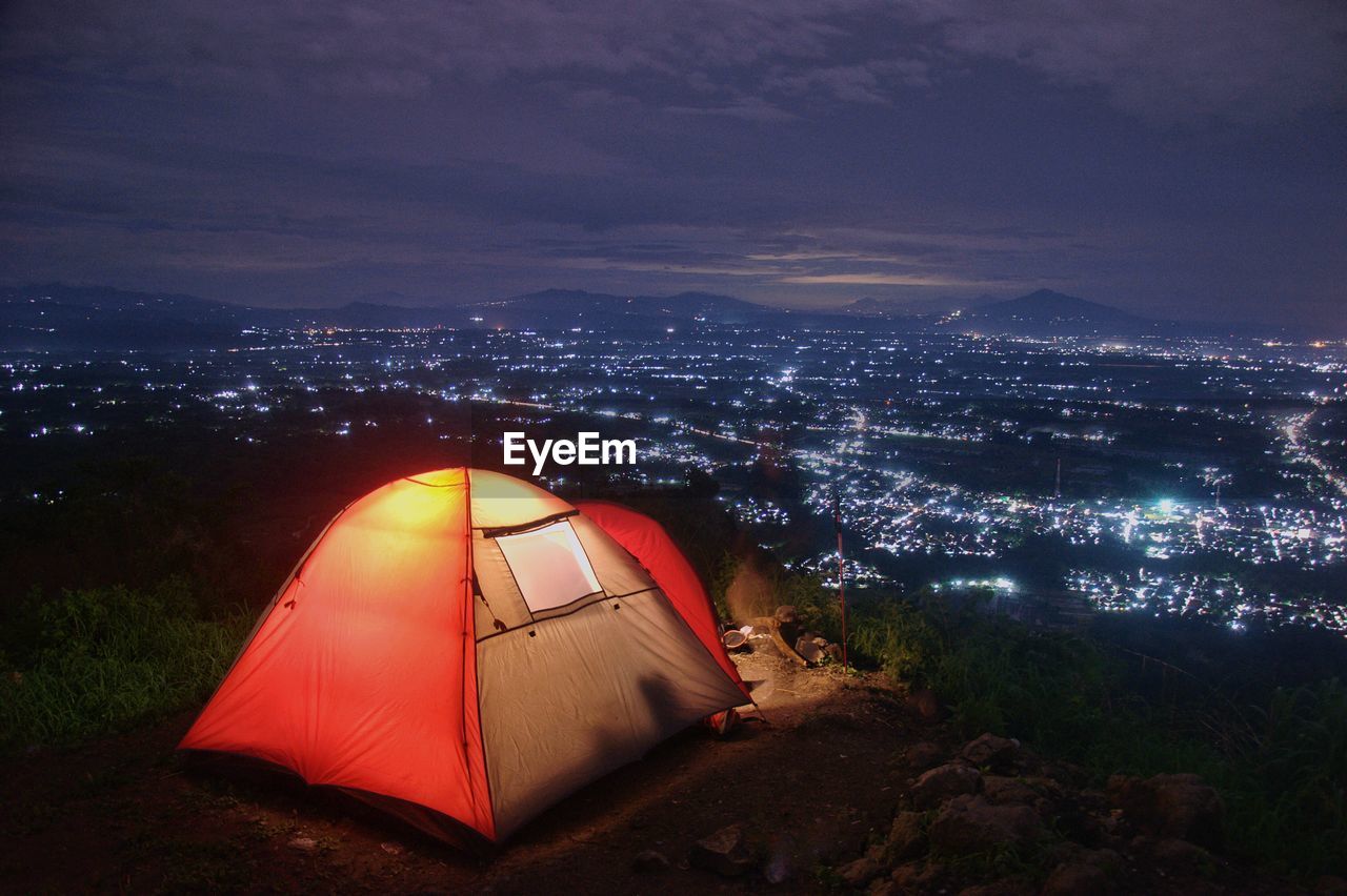 High angle view of illuminated tent against sky at night