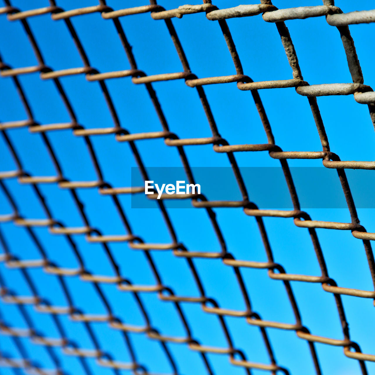 FULL FRAME SHOT OF METALLIC STRUCTURE AGAINST SKY