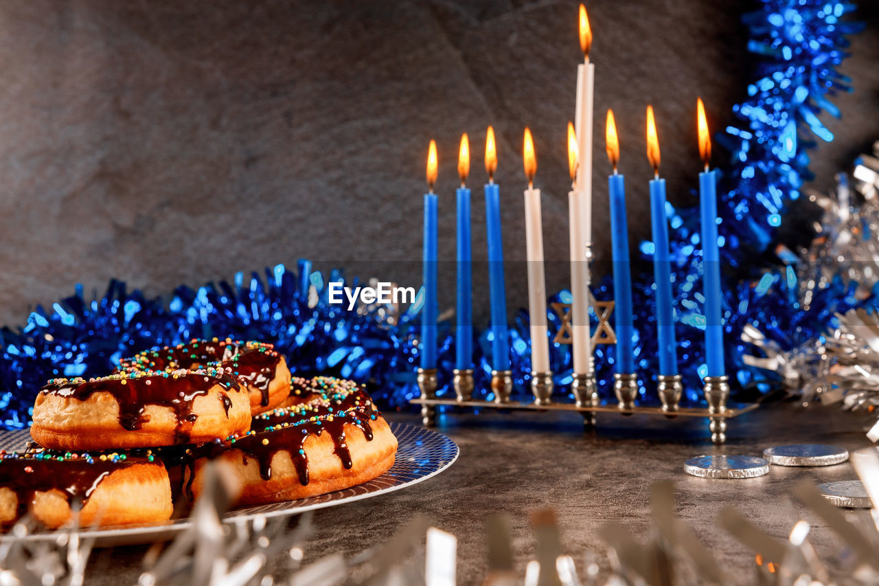 Close-up of donuts in plate by decoration on table