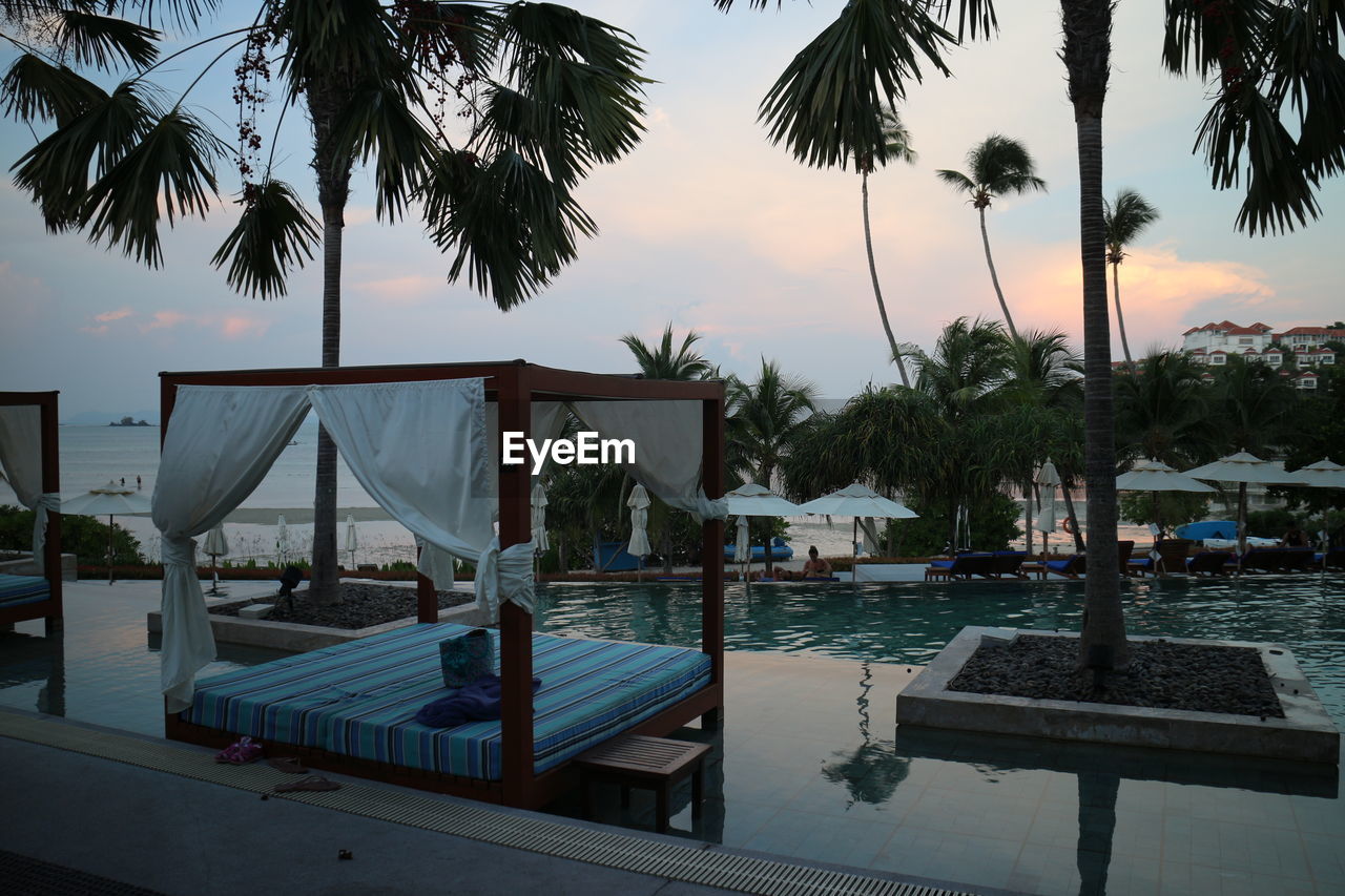 SWIMMING POOL AT BEACH DURING SUNSET