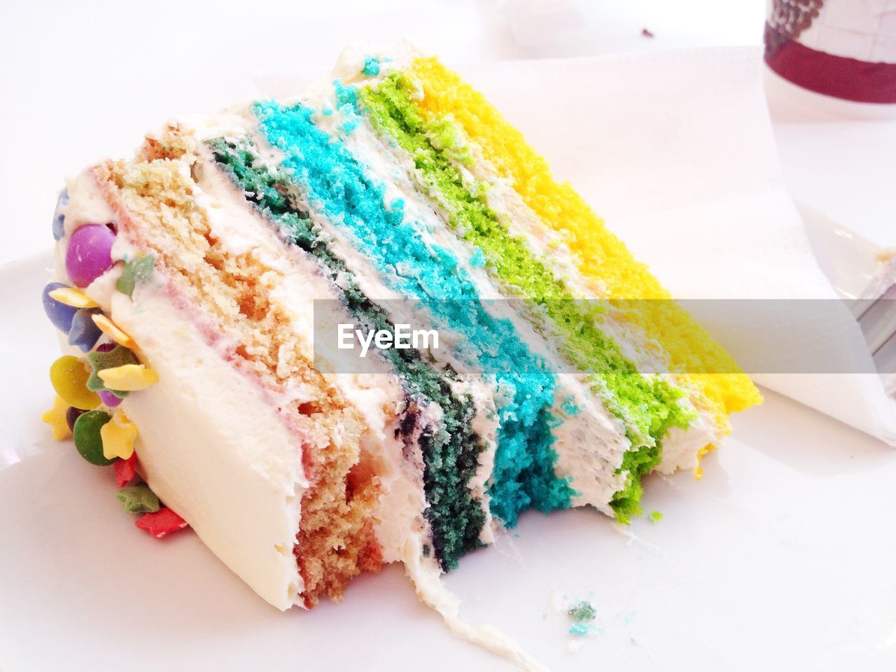 Close-up of colorful cake slice on table