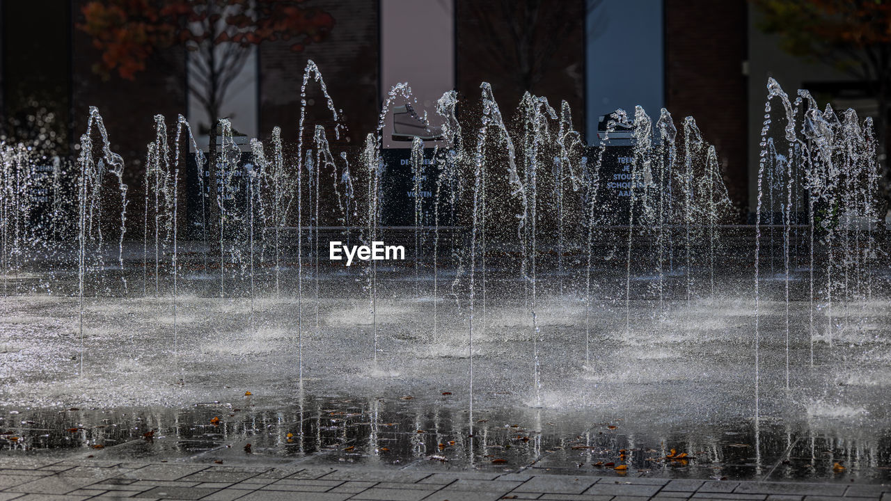 fountain, water, water feature, architecture, freezing, motion, ice, nature, winter, spraying, built structure, no people, splashing, outdoors, reflection, building exterior, long exposure, city, day, plant, frost