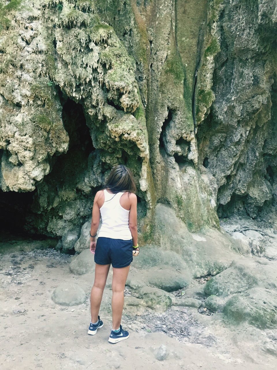 REAR VIEW LOW SECTION OF CHILD ON BEACH