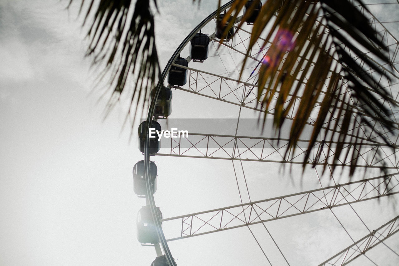 Low angle view of ferris wheel against sky