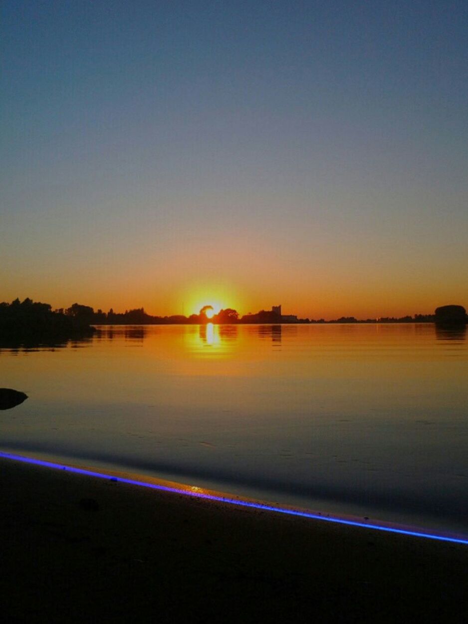 SUNSET OVER CALM SEA