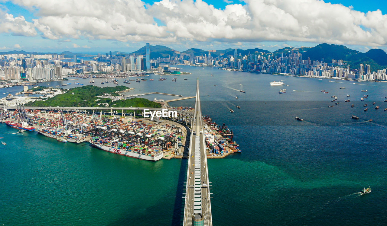 High angle view of cityscape by sea against sky