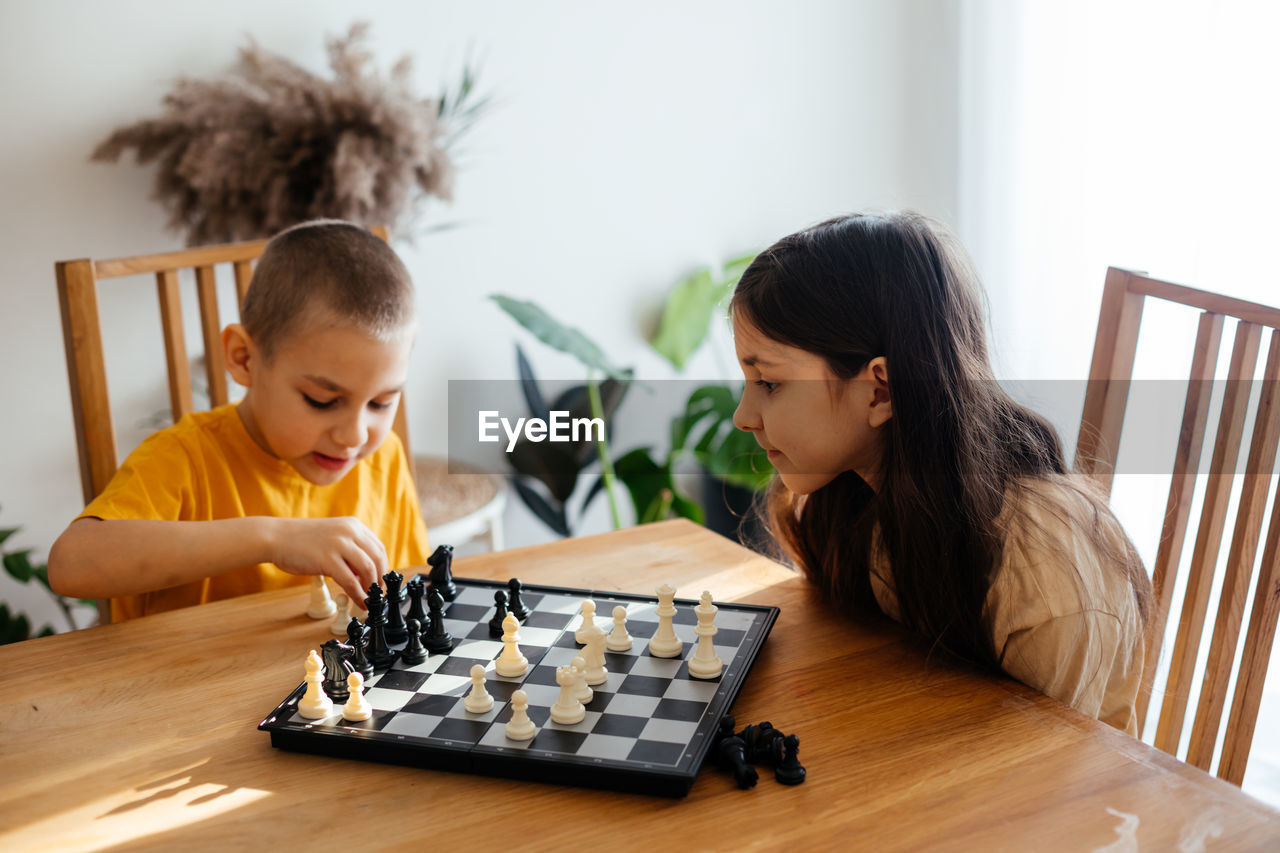 SIDE VIEW OF FATHER PLAYING WITH TABLE