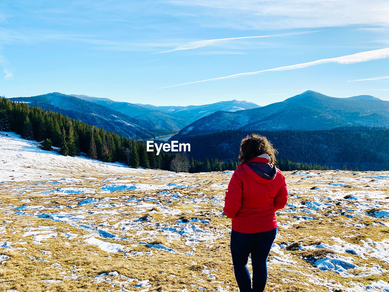 Woman looking at mountains against sky