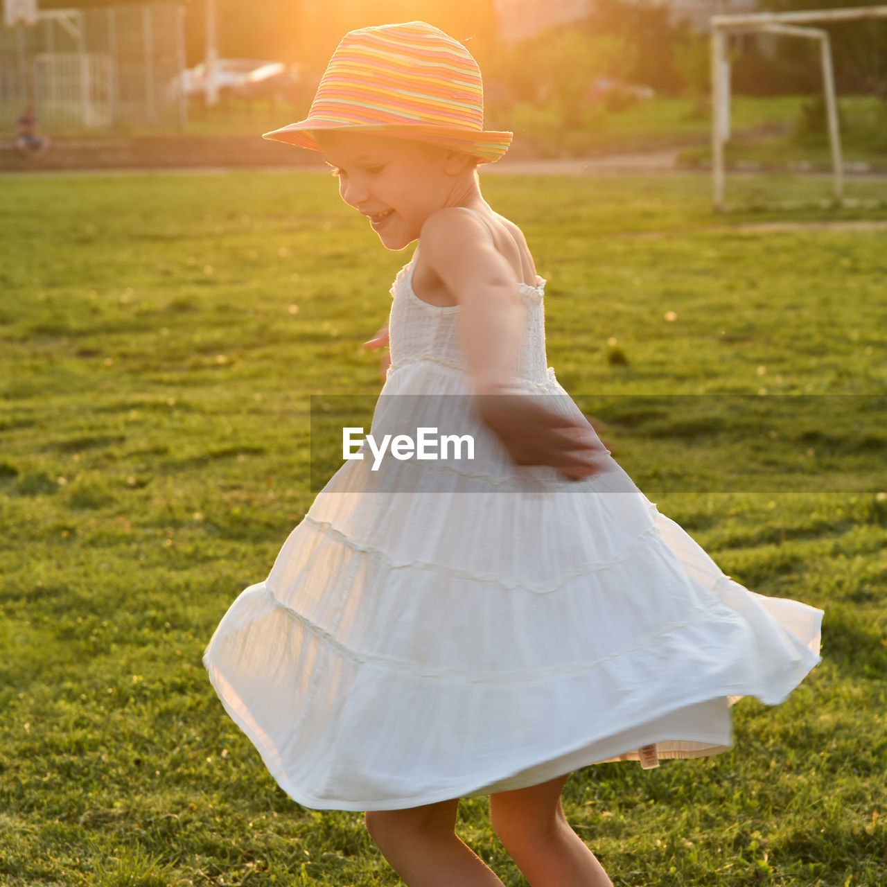 Side view of girl wearing hat on land