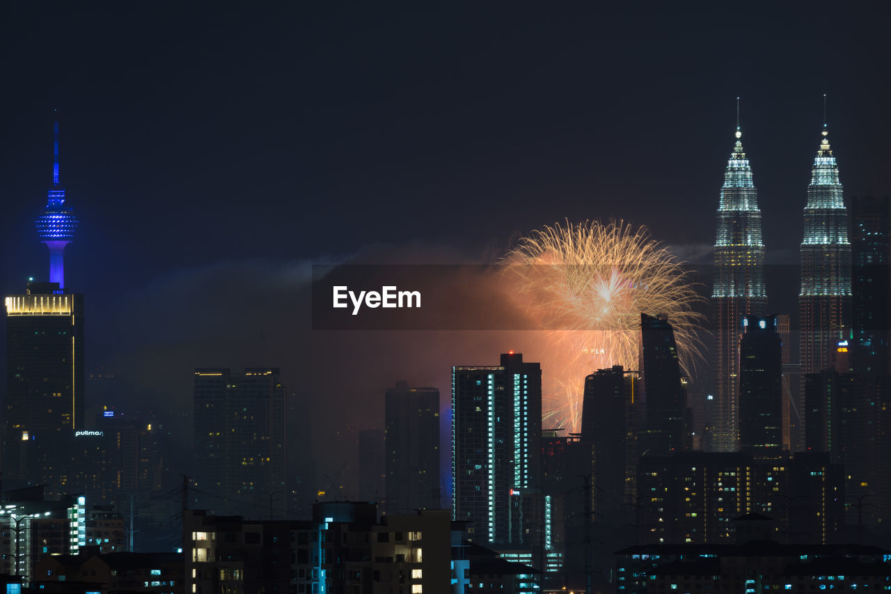 Low angle view of firework display at night