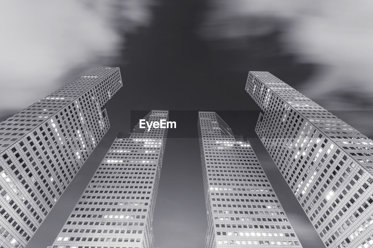 Low angle view of modern buildings against sky in city