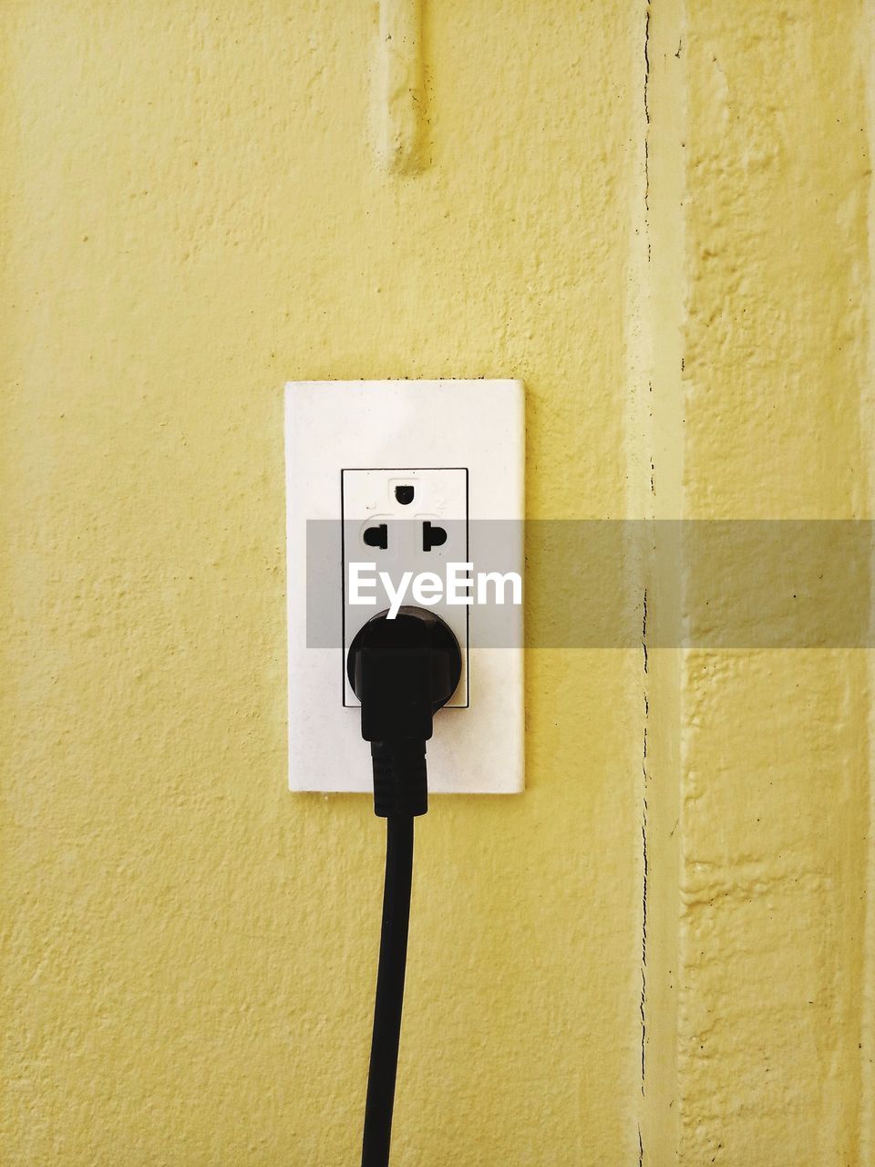 CLOSE-UP OF ELECTRIC LAMP AGAINST WALL