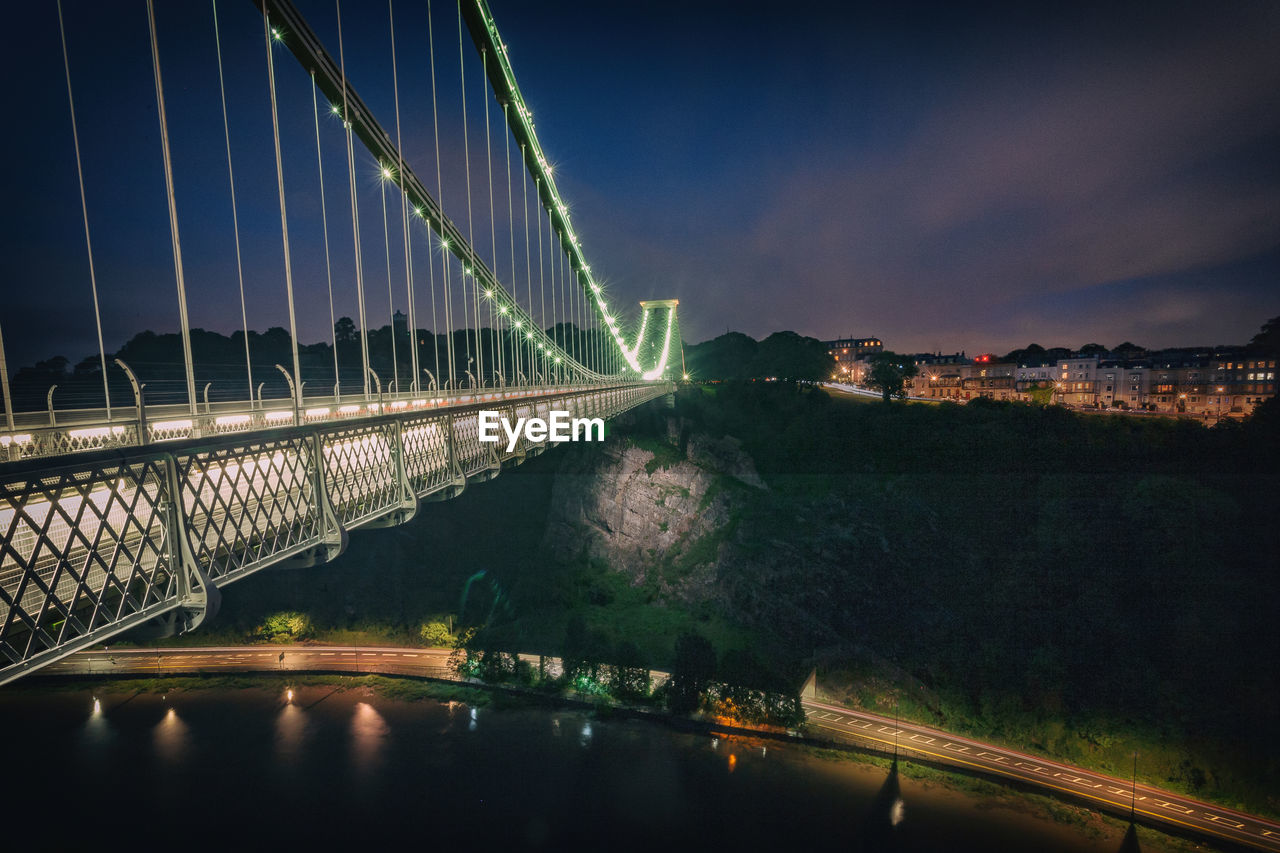 Illuminated suspension bridge in city at night