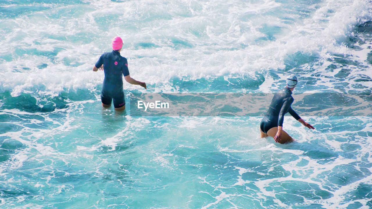 High angle view of swimmers enjoying in sea