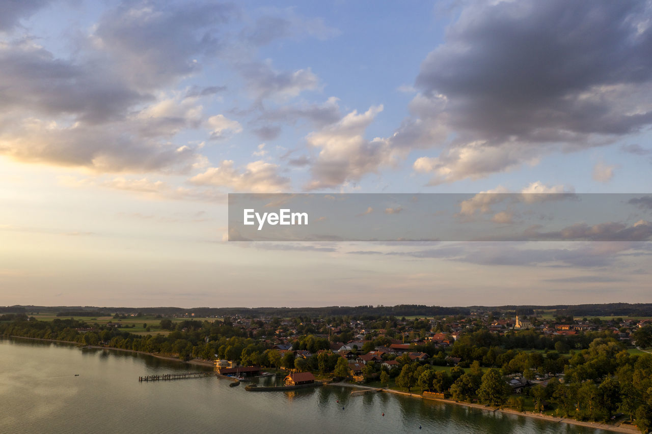 sky, cloud, water, reflection, morning, nature, horizon, architecture, dusk, scenics - nature, beauty in nature, river, environment, landscape, built structure, city, no people, tranquility, building exterior, outdoors, building, shore, travel destinations, travel, tranquil scene, plant, sunlight, tourism, land, cityscape