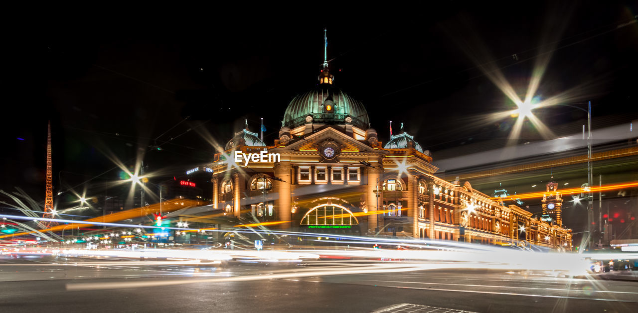 Light trails on road in front of filnders street station at night