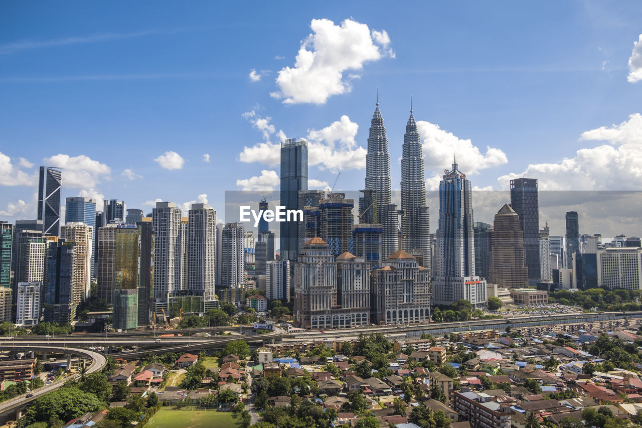 View of skyscrapers against cloudy sky