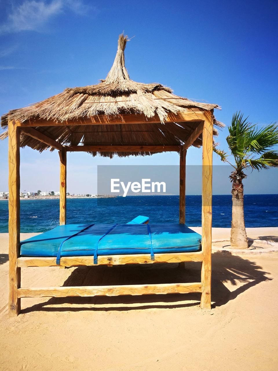 BUILT STRUCTURE ON BEACH AGAINST SKY