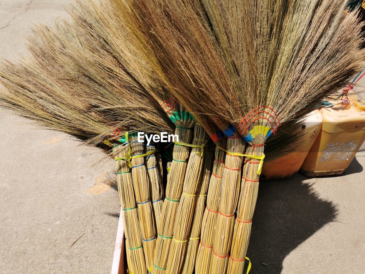 HIGH ANGLE VIEW OF MULTI COLORED UMBRELLAS ON WOODEN WALL