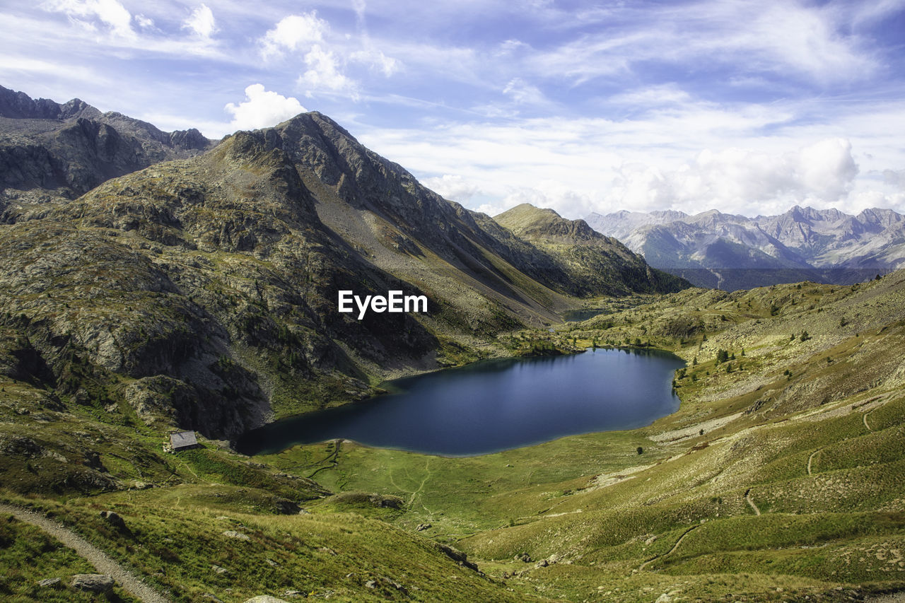 Scenic view of lake and mountains against sky